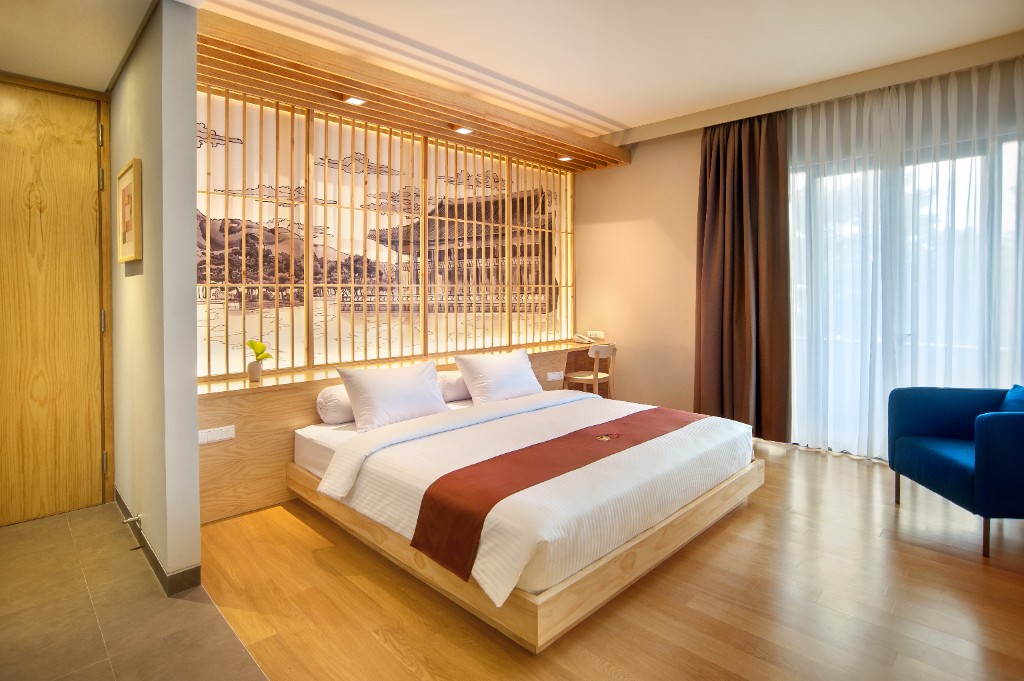 Deluxe room workspace and bed view